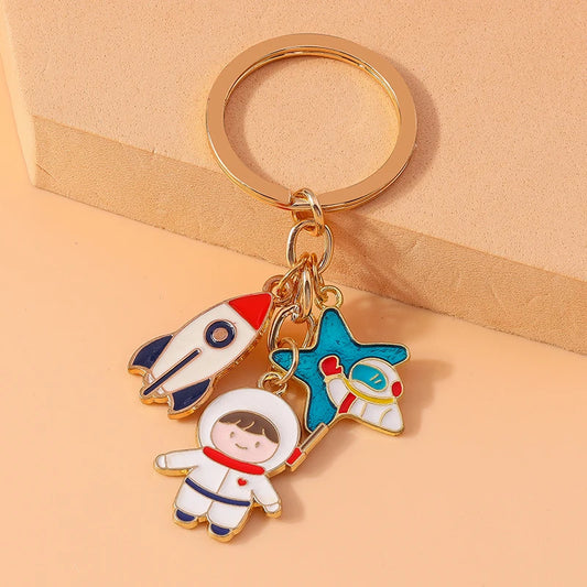 Cute Cartoon Astronaut Keychain – Enamel Rocket Pendant for Women & Girls